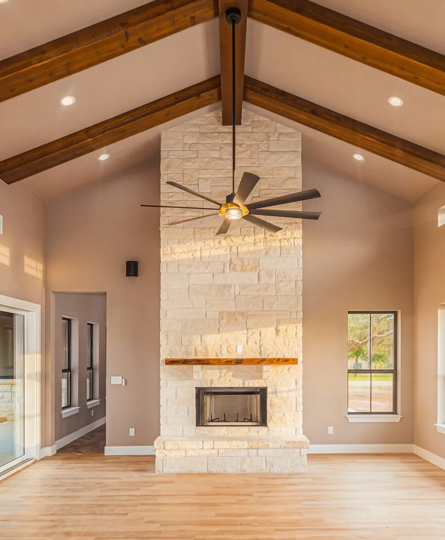 Stone fireplace detail with wood beam ceiling